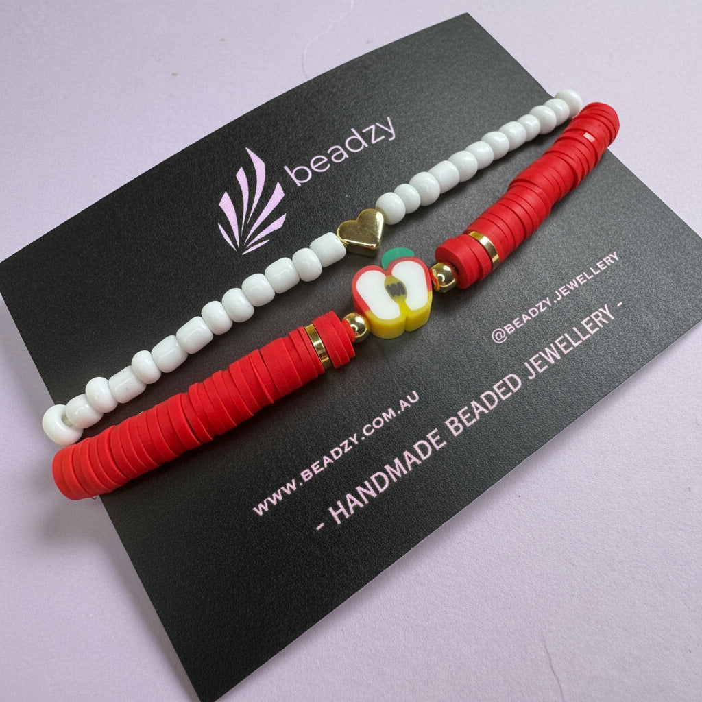 Two beaded bracelets on a black card with brand name on a yellow background - Beadzy