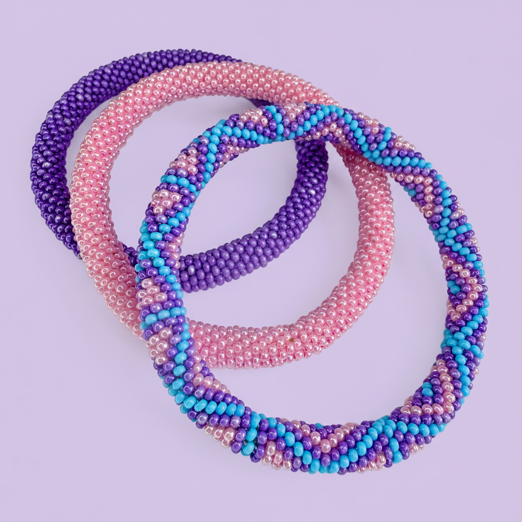 Three beaded bracelets in purple, pink, and blue on a light purple background - Beadzy