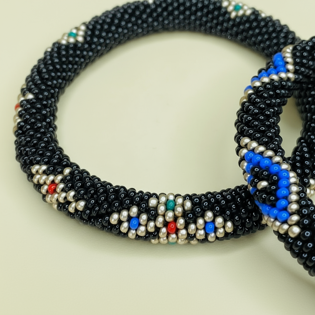 Evil eye accent beaded bracelets with black, blue, and silver beads on a light background - Beadzy