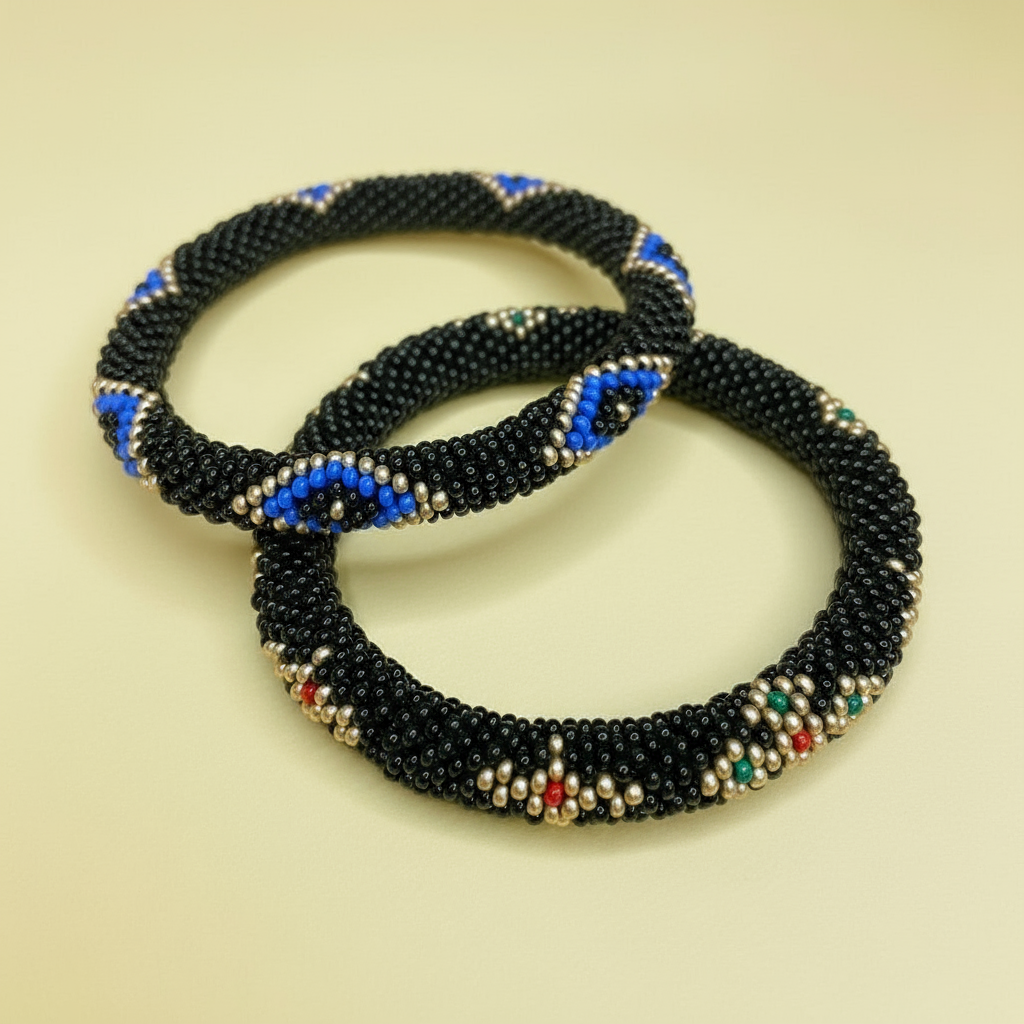 Black and blue beaded bracelet with evil eye accents on a beige background - Beadzy