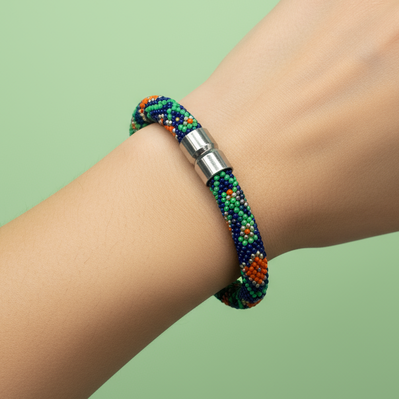 Hand wearing a colorful beaded bracelet on a green background - Beadzy