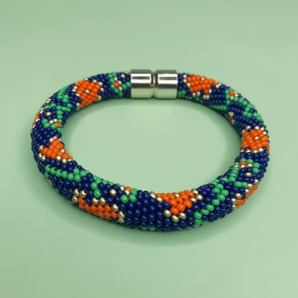 Beaded bracelet with blue, orange, and green pattern on a light green background - Beadzy