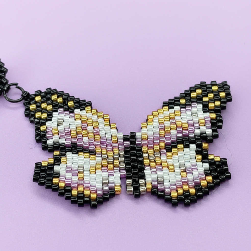Beaded butterfly earrings on a purple background - Beadzy