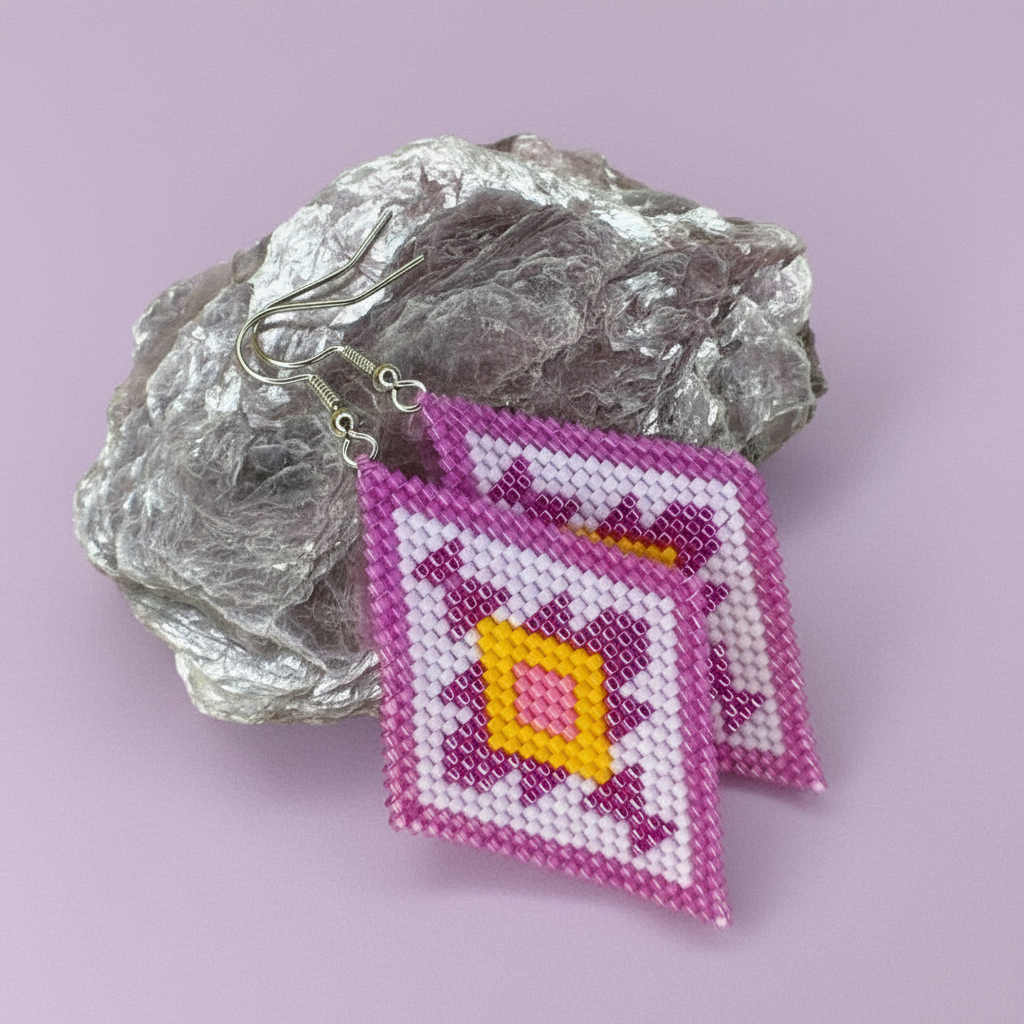 Beaded earrings with a geometric pattern on a purple rock against a light purple background - Beadzy