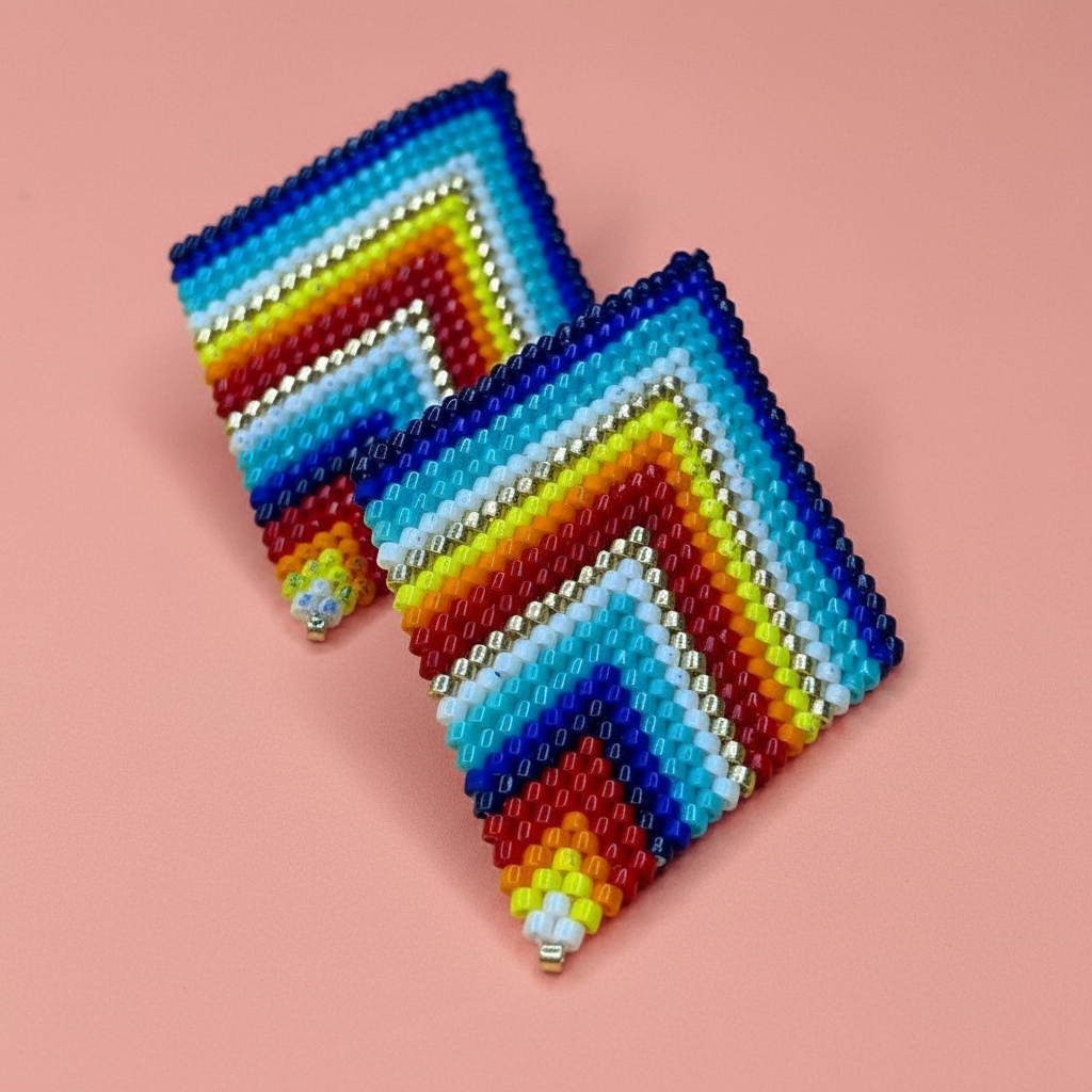 Colorful rainbow beaded earrings with zigzag pattern on a pink background - Beadzy