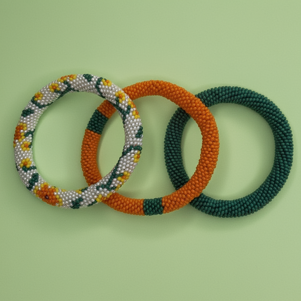 Three beaded bracelets in orange, green, and white on a light green background - Beadzy