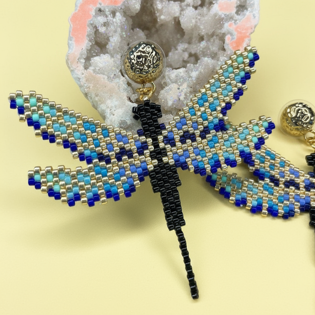 Beaded dragonfly earring on a textured surface with a yellow background - Beadzy