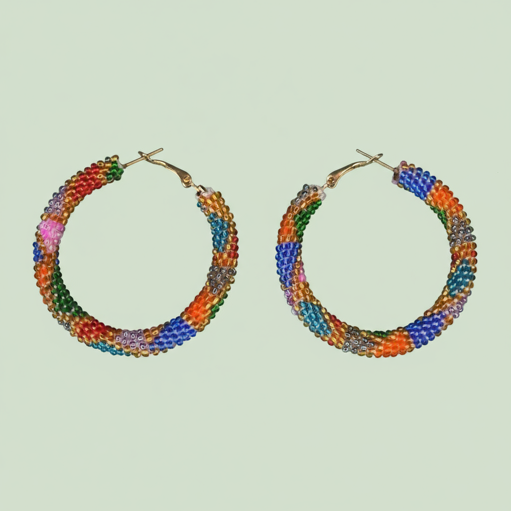 Colorful beaded hoop earrings on a light green background - Beadzy