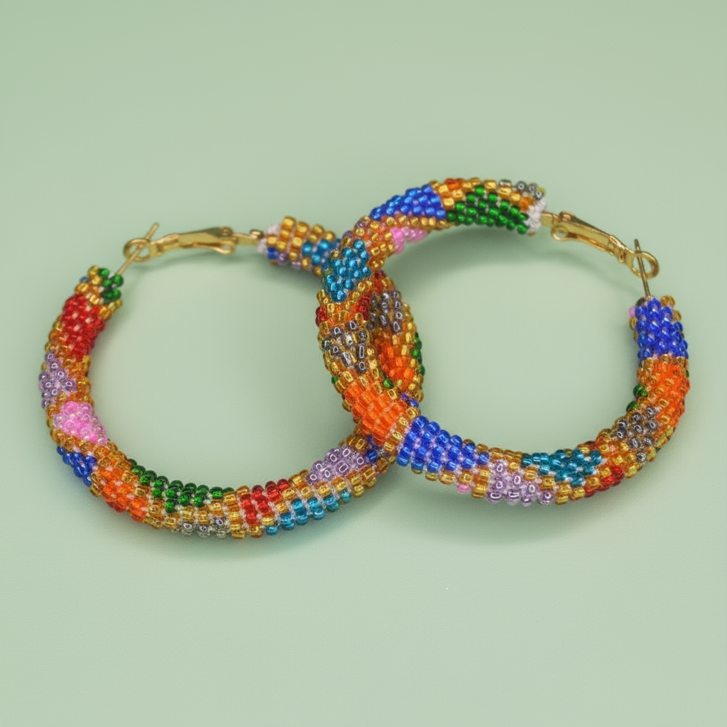 Colorful beaded hoop earrings on a light green background - Beadzy