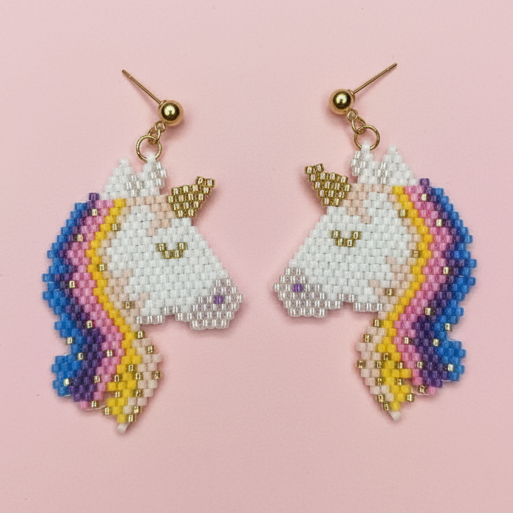 Unicorn-shaped beaded earrings on a pink background - Beadzy