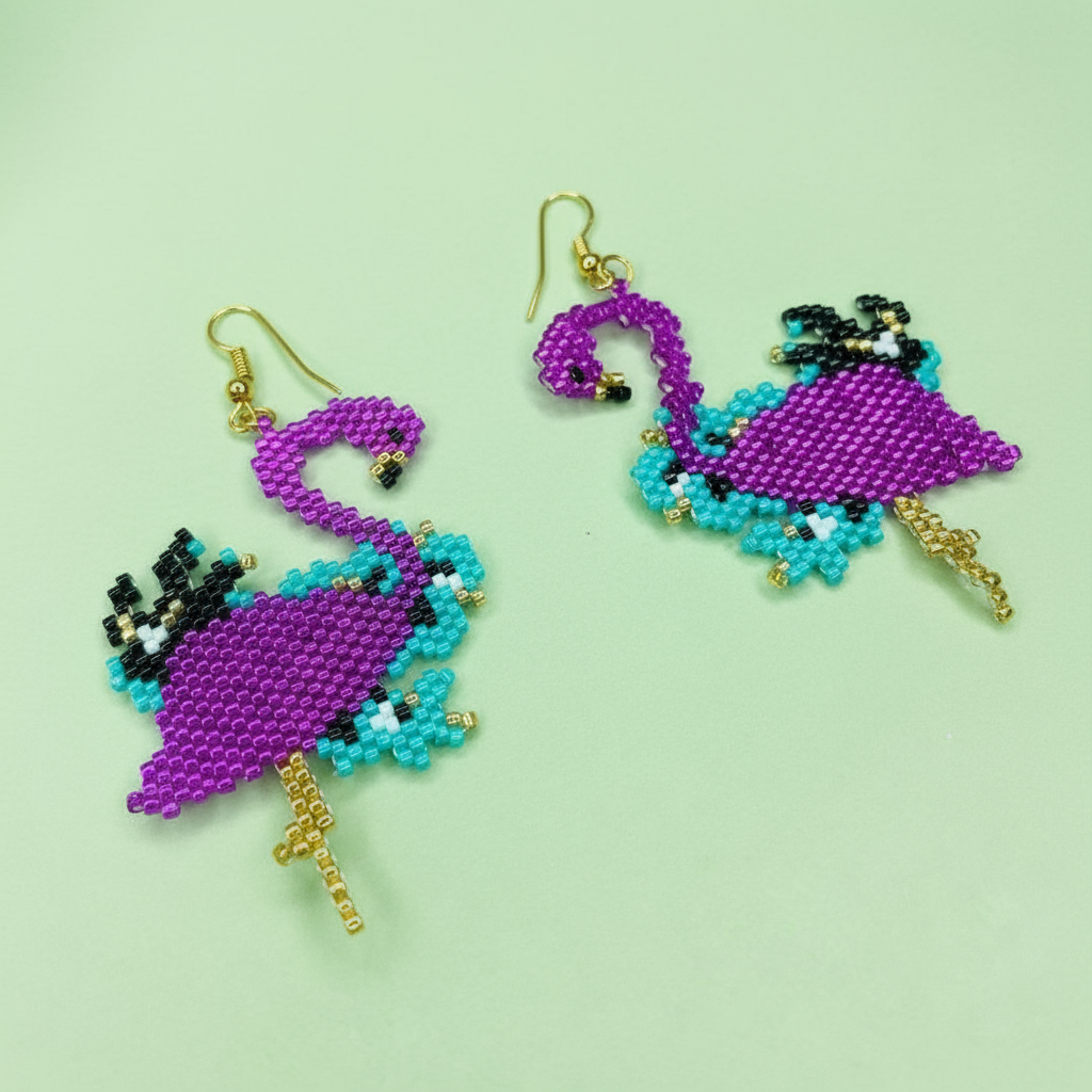 Beaded flamingo earrings on a light green background - Beadzy