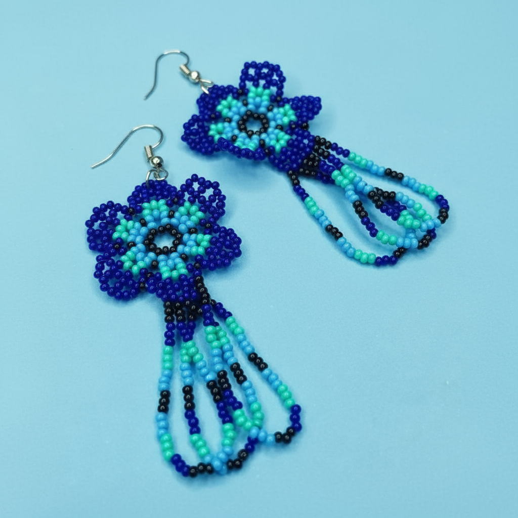 Beaded blue flower earrings on a light blue background - Beadzy