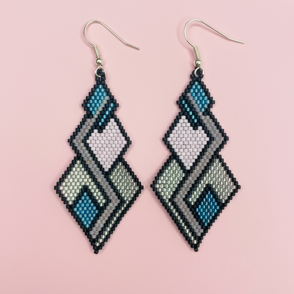 Pair of geometric patterned earrings on a pink background - Beadzy