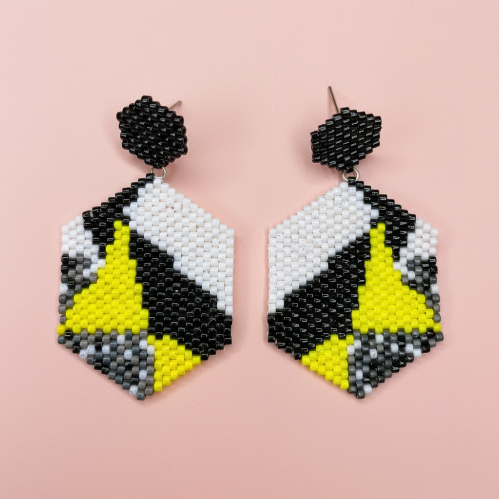 Geometric beaded earrings with black, yellow, and white pattern on a pink background - Beadzy