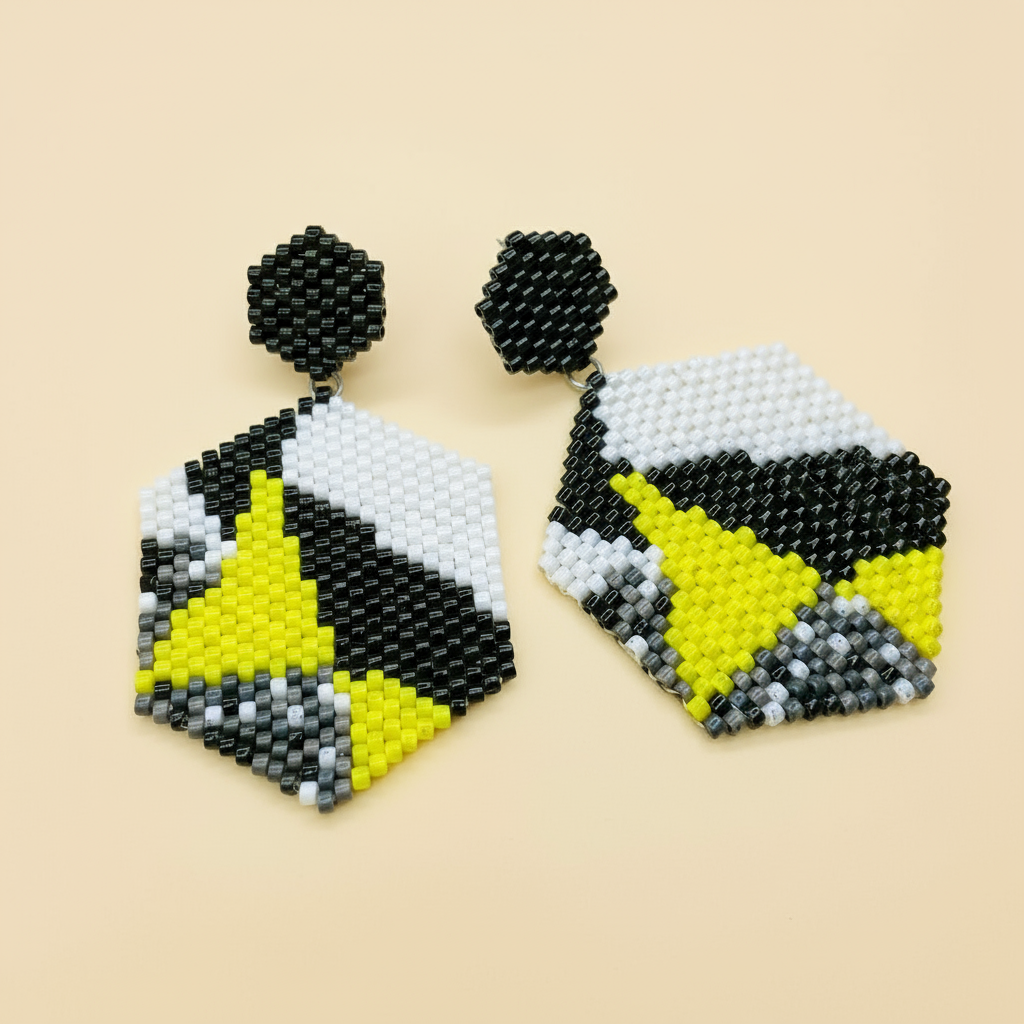 Hexagonal beaded earrings with black, yellow, and gray pattern on a beige background - Beadzy 