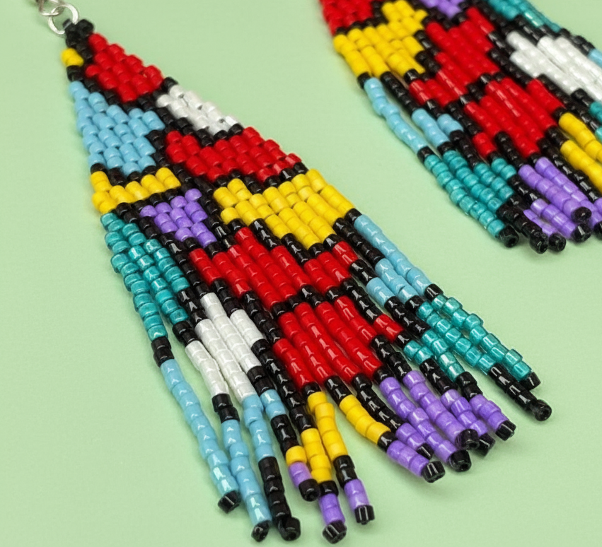Colorful beaded earrings on a light green background - Beadzy