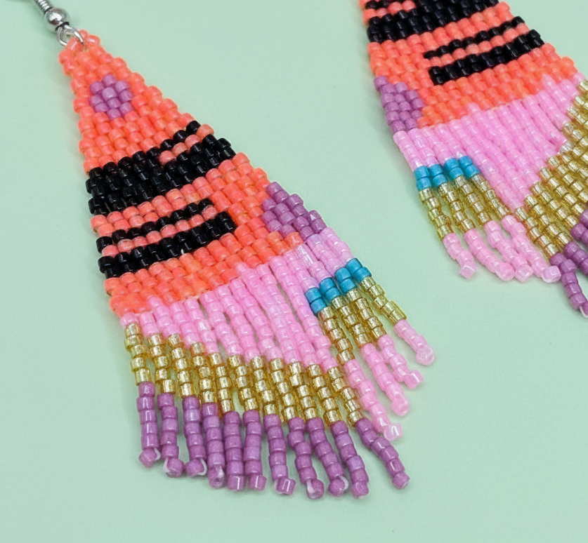 Colorful beaded earrings on a light green background - Beadzy