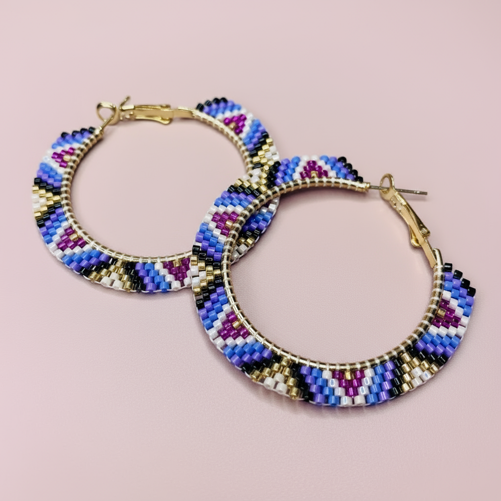 Colorful beaded hoop earrings on a pink background - Beadzy
