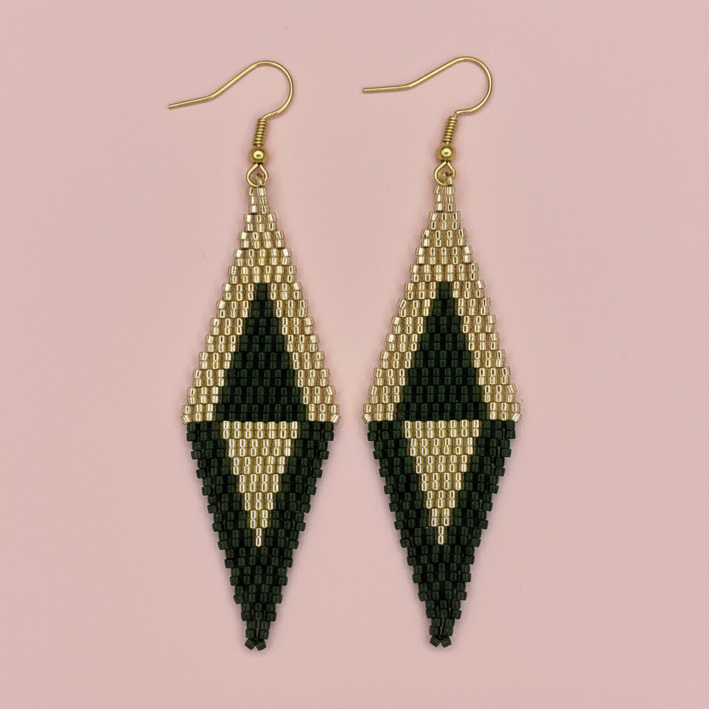Black and gold beaded earrings on a pink background - Beadzy