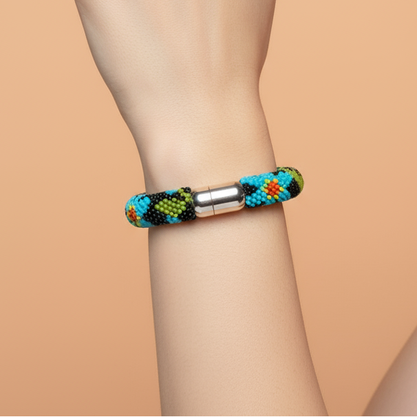 Hand wearing a colorful beaded bracelet on a beige background - Beadzy