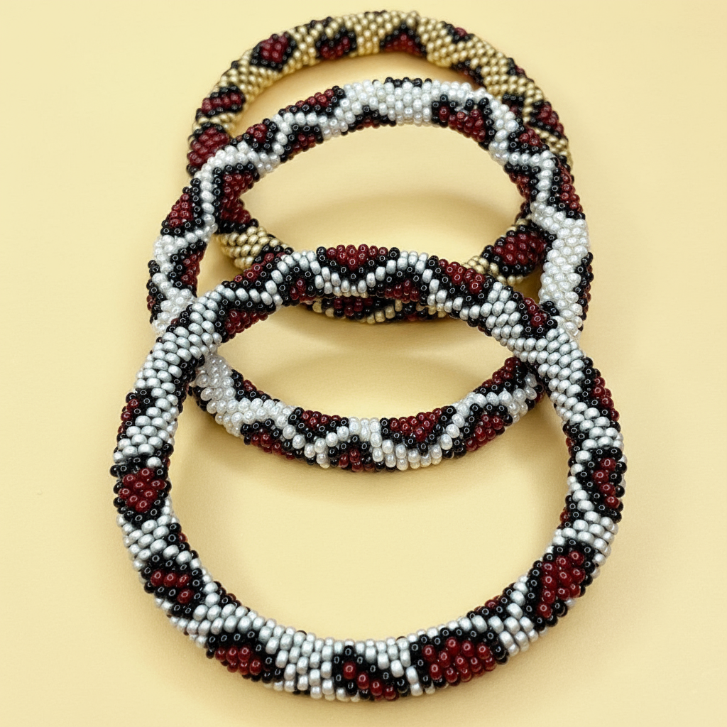 Three leopard pattern beaded bracelets in brown, beige, and black on a yellow background - Beadzy