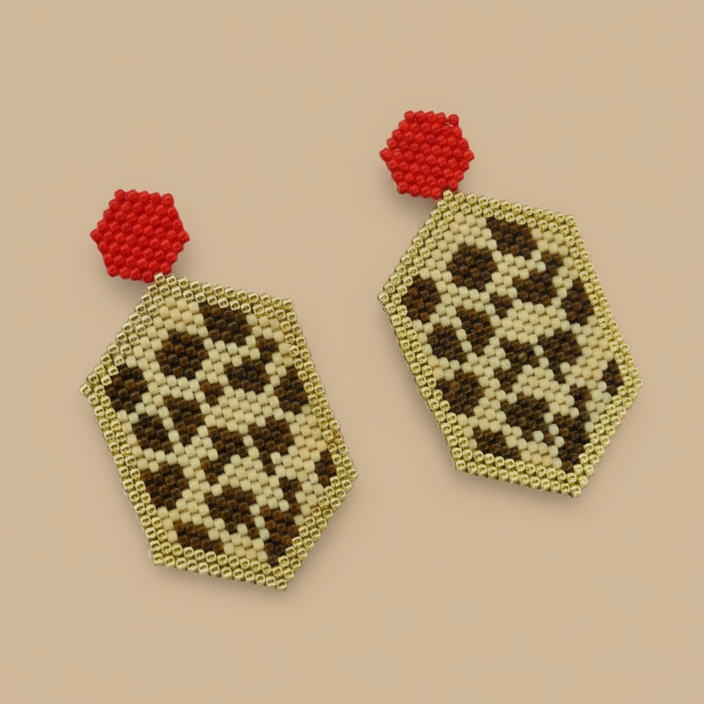 Pair of leopard pattern beaded earrings with red tops on a beige background - Beadzy