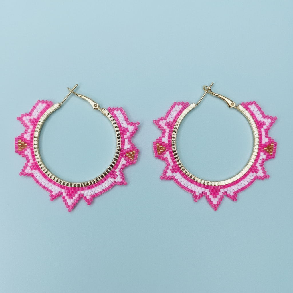 Pair of pink beaded hoop earrings on a light blue background- Beadzy