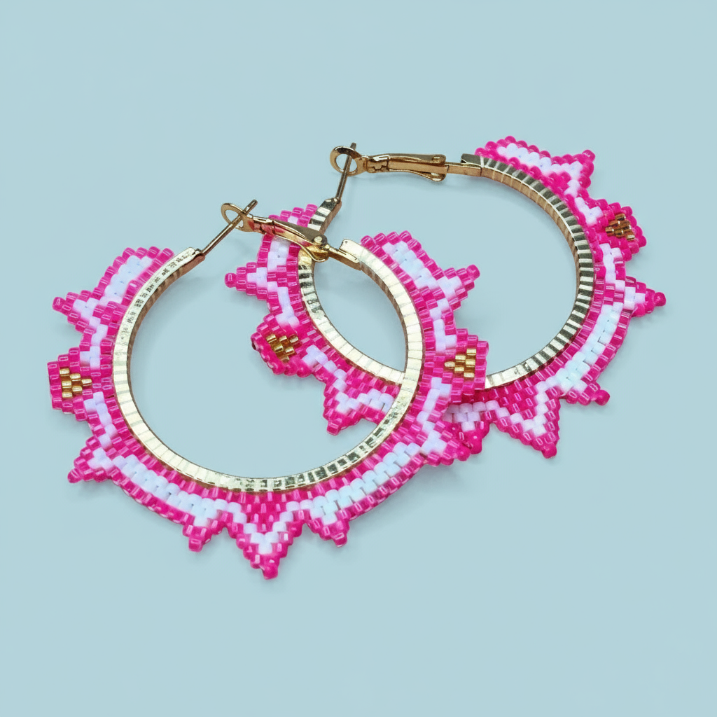 Pair of pink beaded hoop earrings on a light blue background- Beadzy