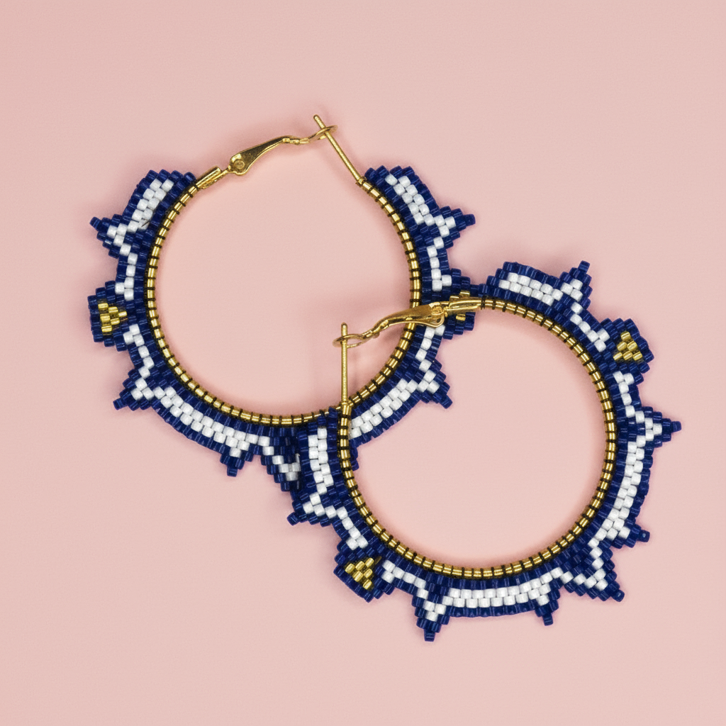 Pair of beaded hoop earrings with blue, white, and gold design on a pink background - Beadzy
