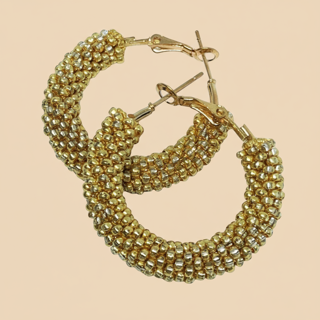 Gold beaded hoop earrings on a beige background - Beadzy
