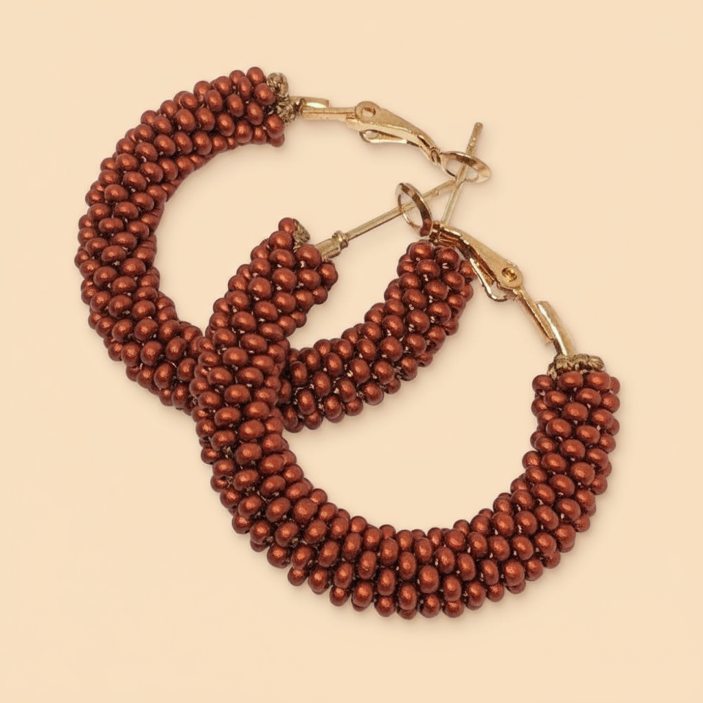 Pair of bronze color beaded hoop earrings on a beige background -Beadzy