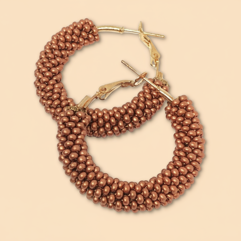 Pair of brown beaded hoop earrings on a beige background - Beadzy