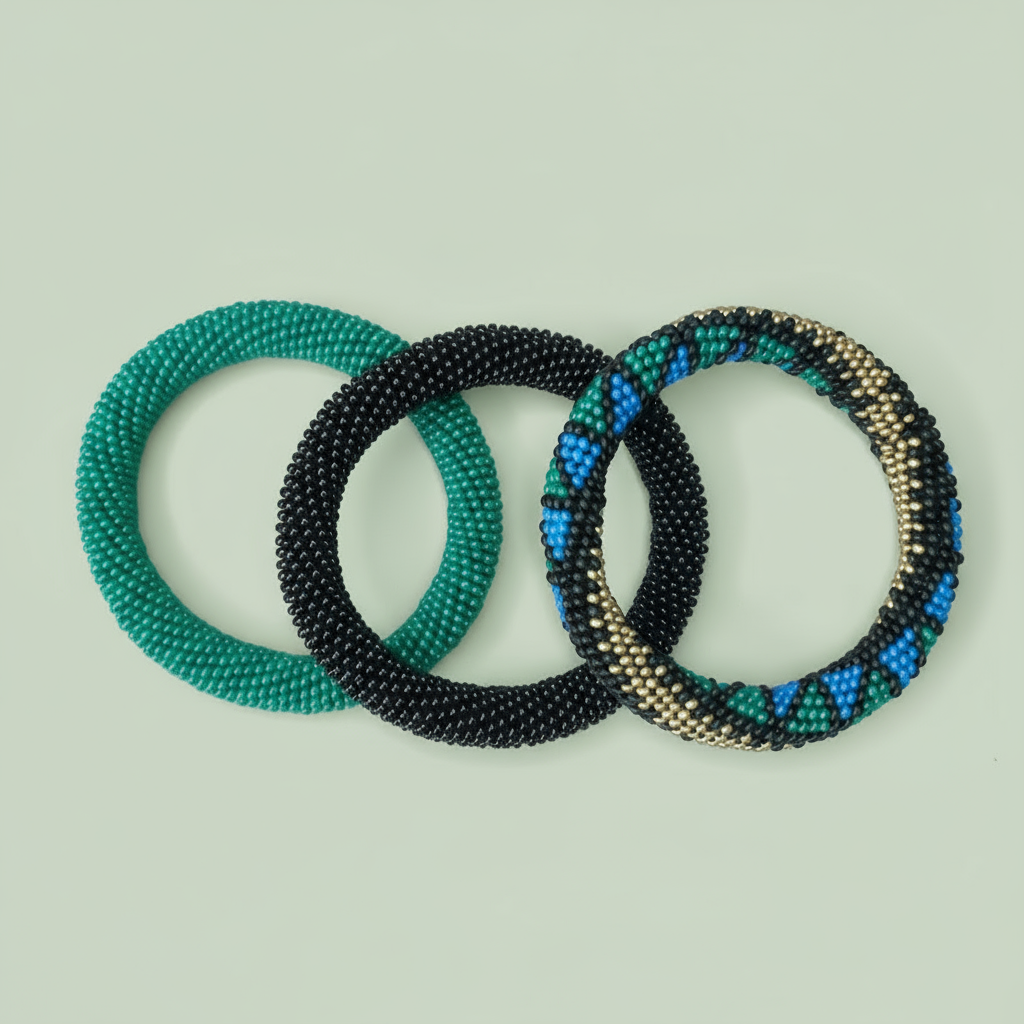 Three beaded bracelets in green, black, and multicolor on a light green background - Beadzy