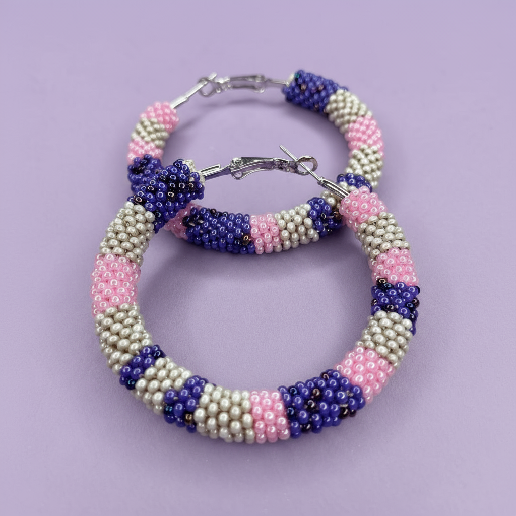 Beaded hoop earrings with pink, white, and purple beads on a light purple background - Beadzy