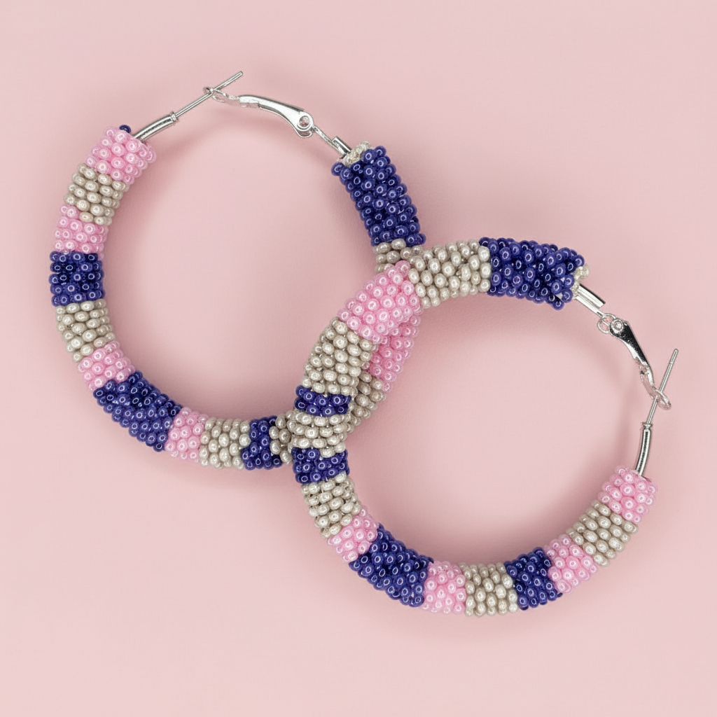 Hoop earrings with multicolored bead design on a pink background - Beadzy