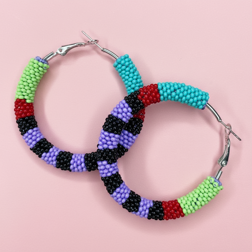 Colorful beaded hoop earrings on a pink background - Beadzy