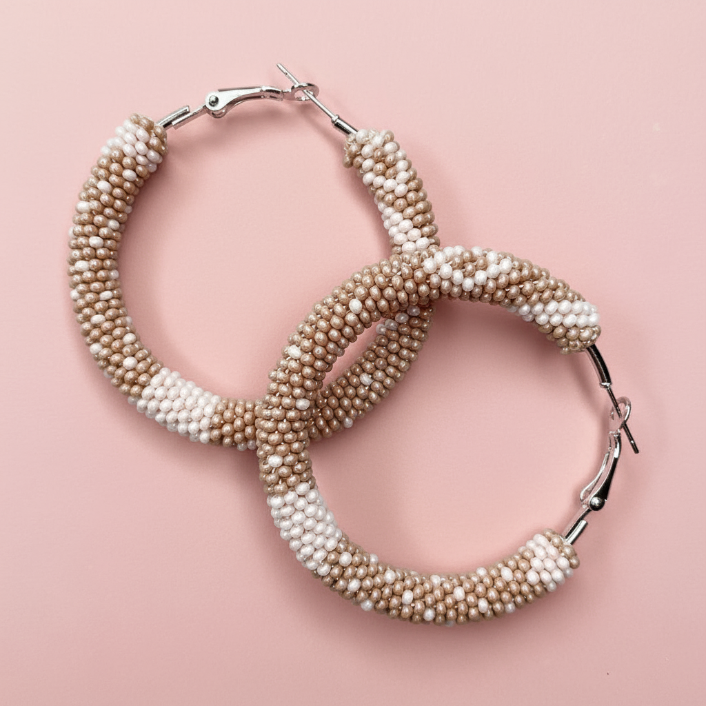 Pair of beaded hoop earrings on a pink background - Beadzy