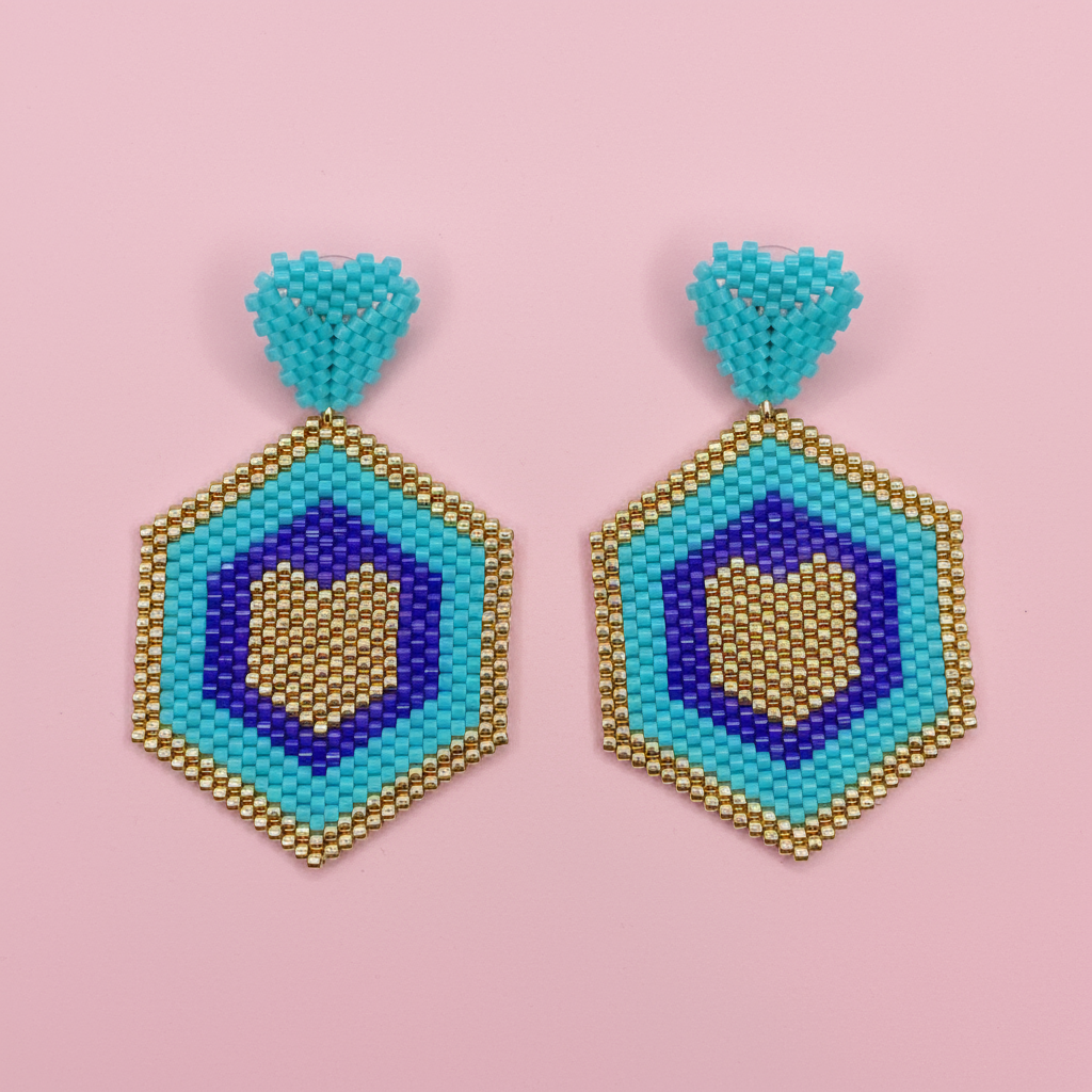 Hexagonal beaded earrings with blue, gold, and purple on a pink background - Beadzy