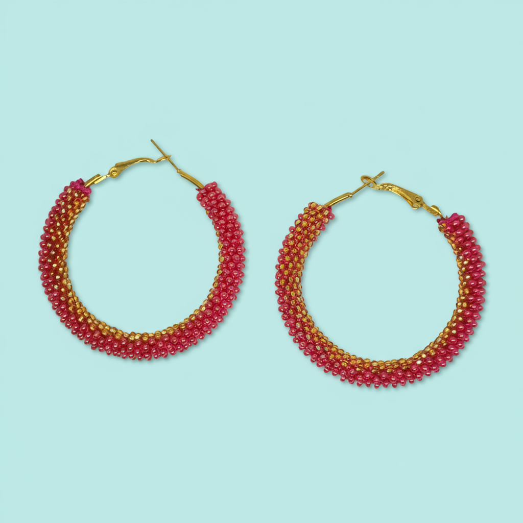 Pair of beaded hoop earrings on a light blue background - Beadzy