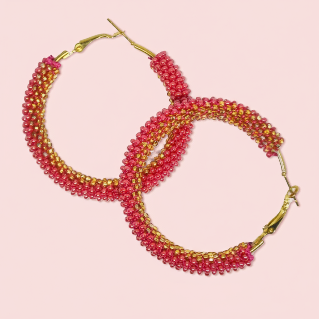 Beaded hoop earrings with pink and gold beads on a pink background - Beadzy
