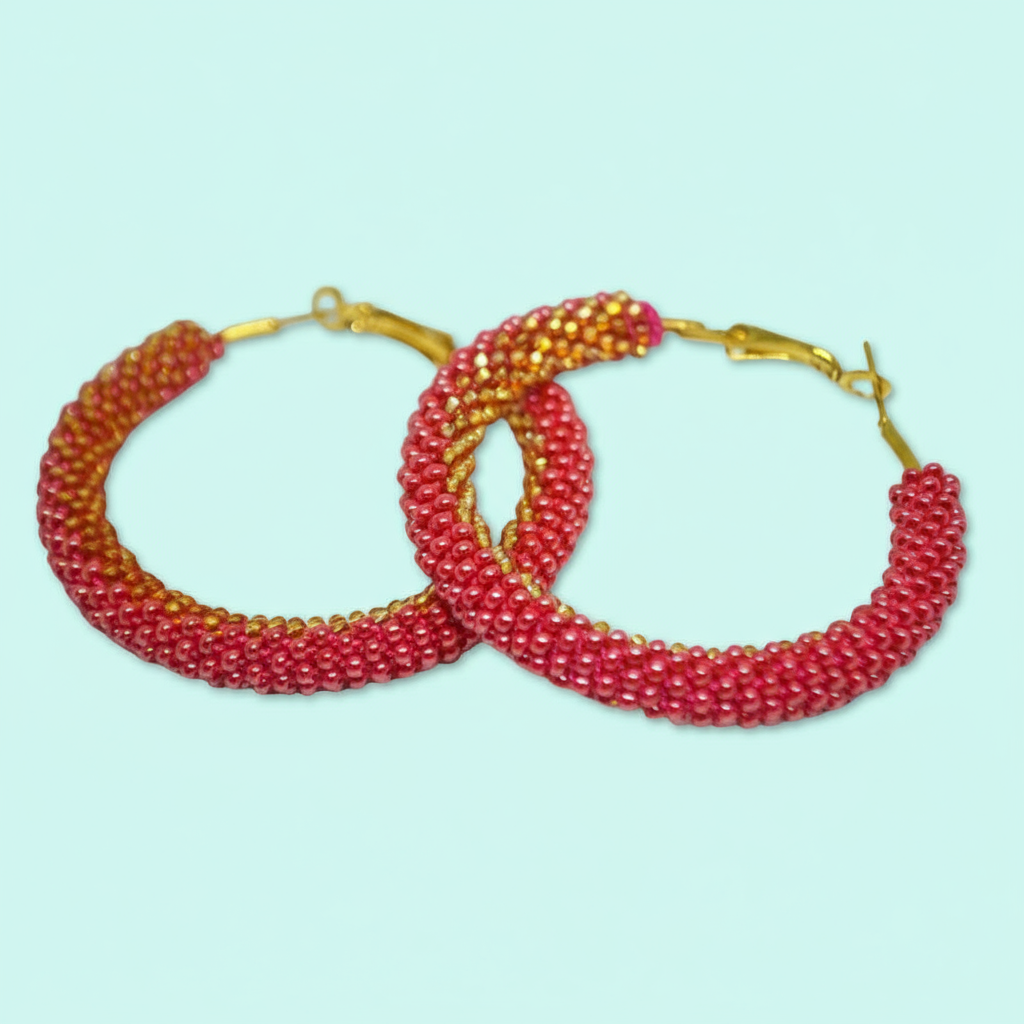 Pair of red beaded hoop earrings on a light blue background - Beadzy