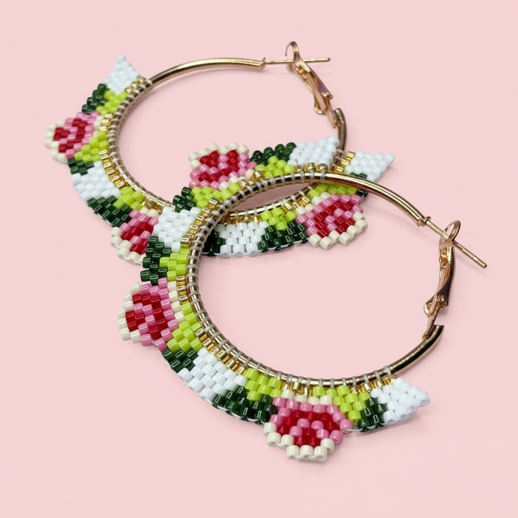 Hoop earrings with floral bead design on a pink background - Beadzy
