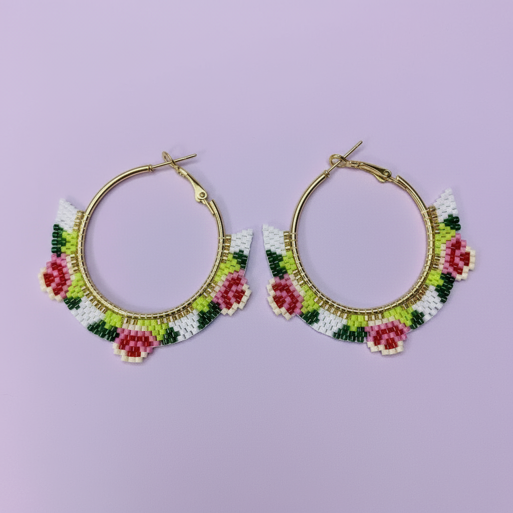 Hoop earrings with floral bead designs on a light purple background - Beadzy