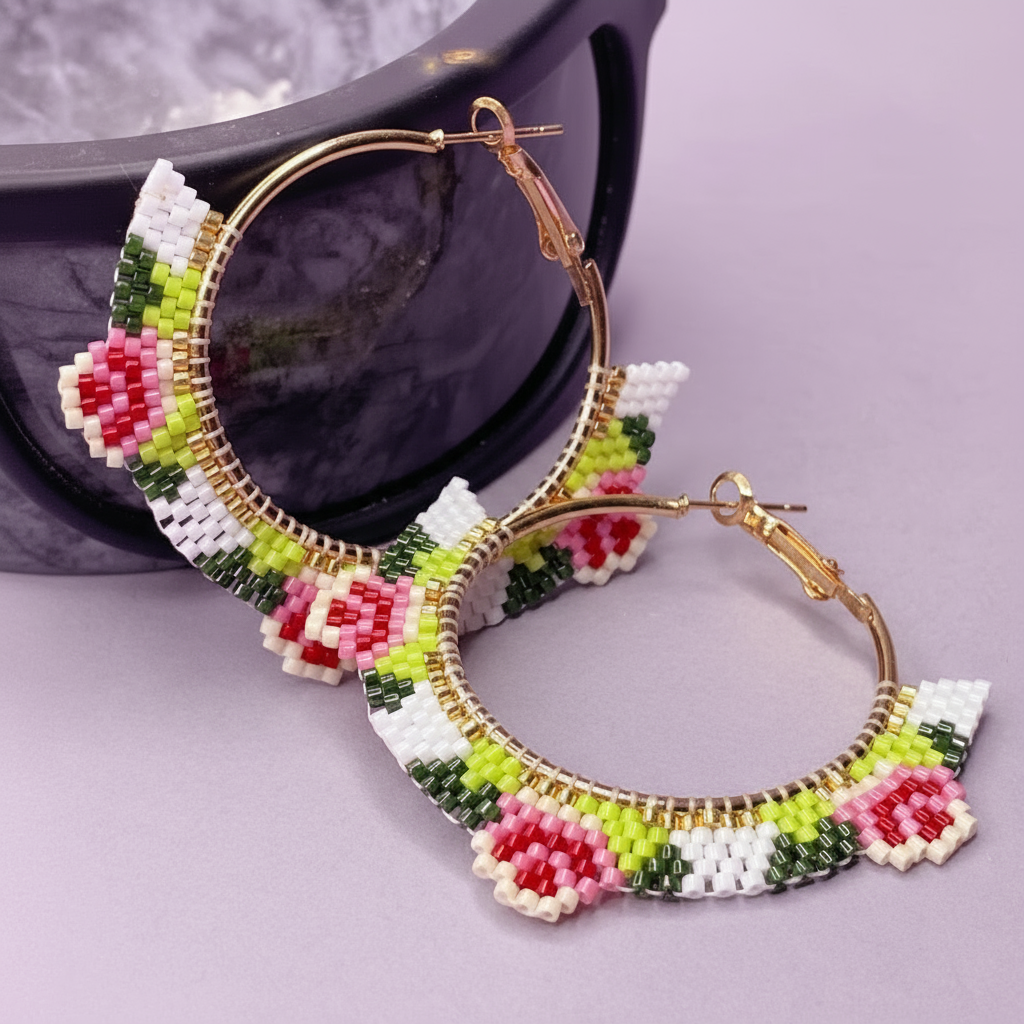 Colorful beaded hoop earrings with floral designs on a light purple background - Beadzy