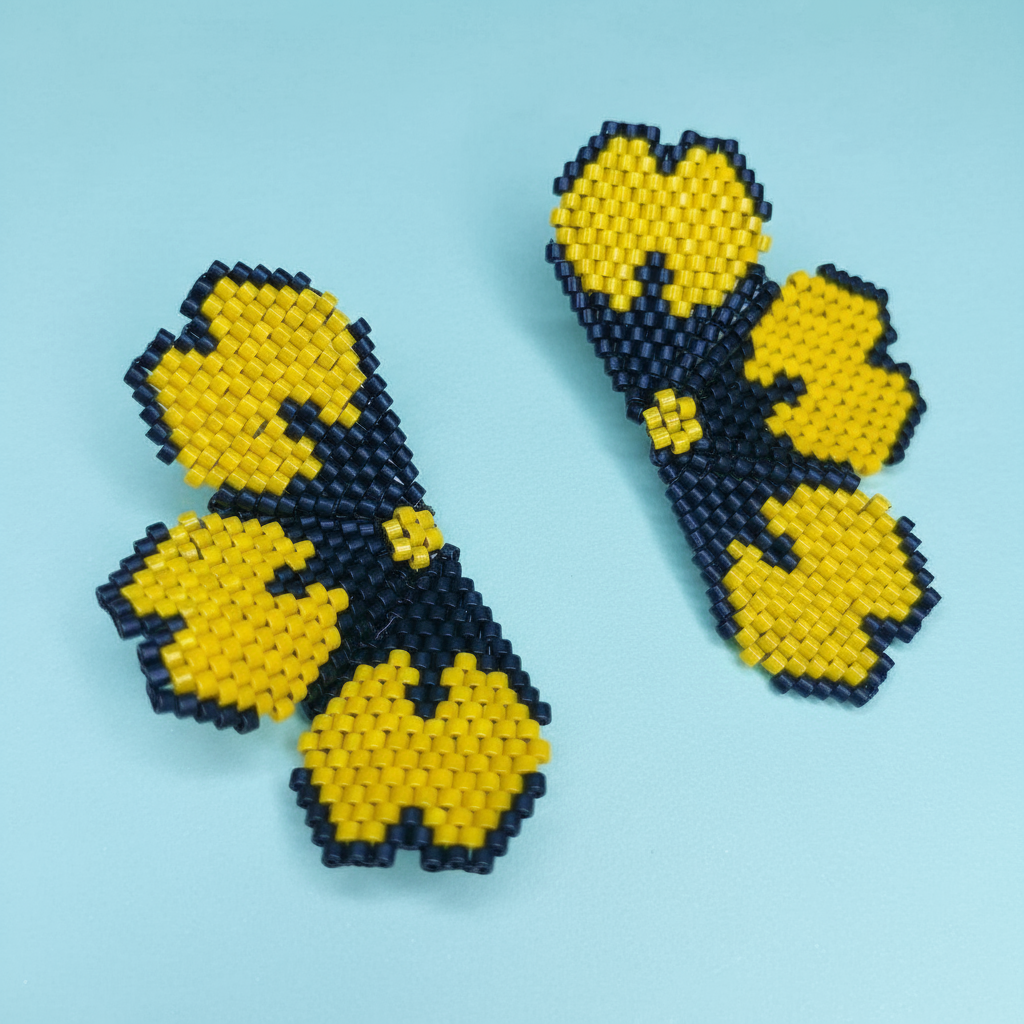 Beaded flower earrings on a light blue background - Beadzy