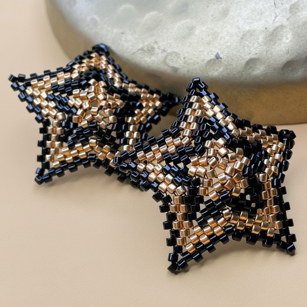 Beaded star-shaped earrings on a neutral background - Beadzy
