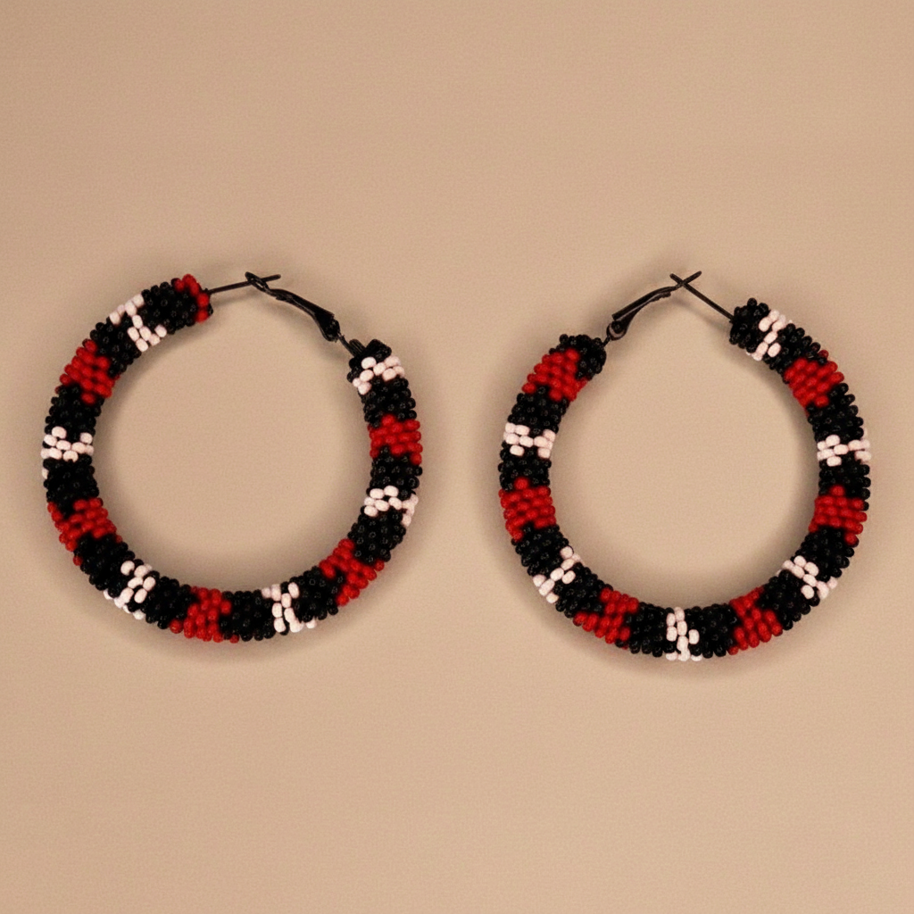 Pair of hoop earrings with black, red, and white beads on a beige background - Beadzy