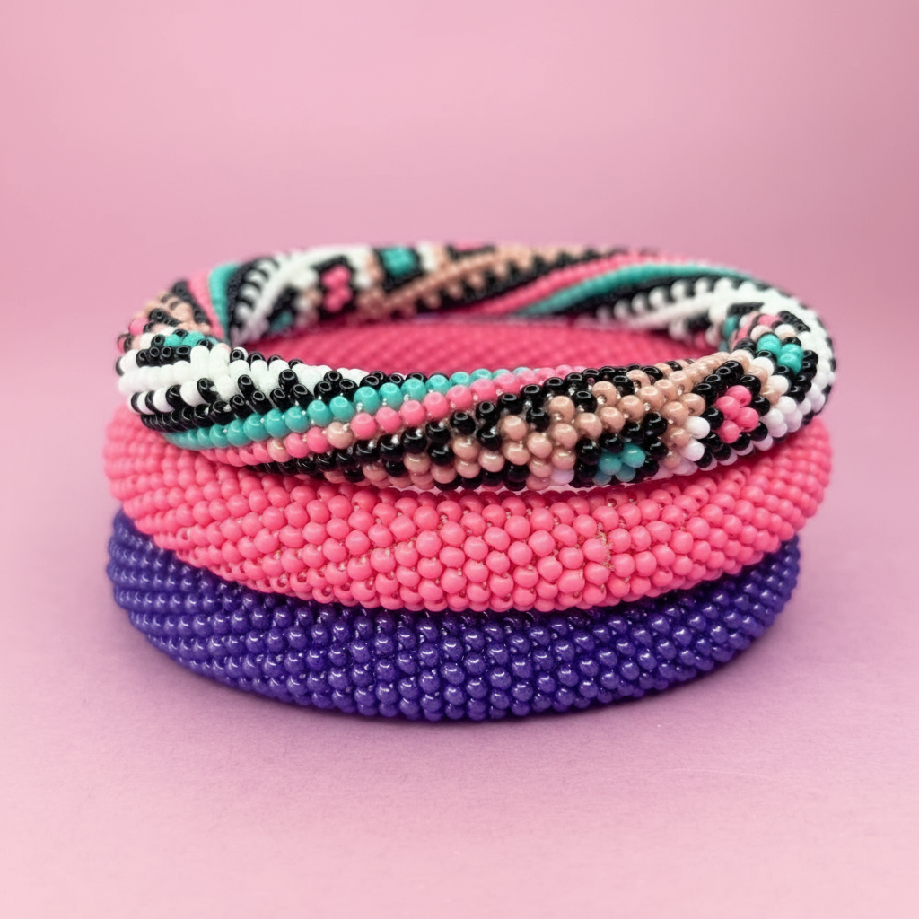 Stack of colorful beaded rope bracelets on a pink background - Beadzy