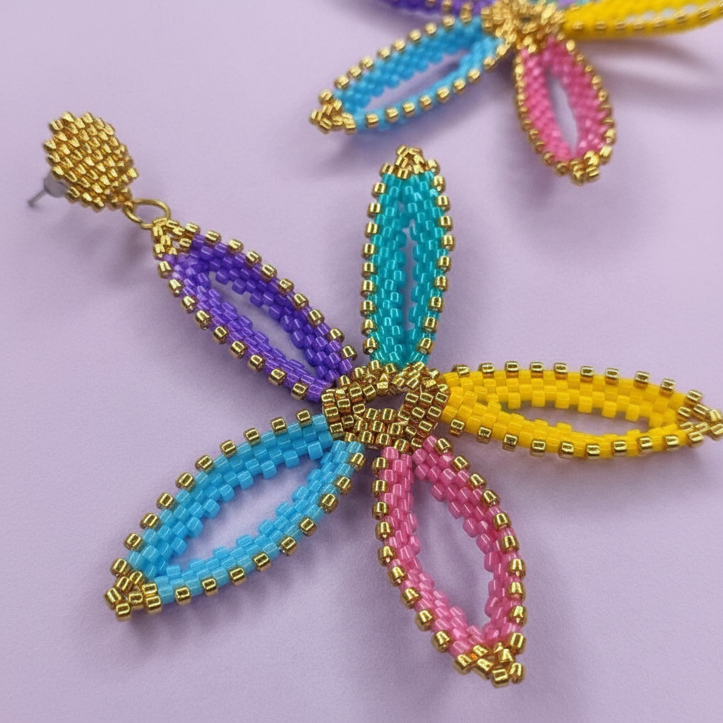 Colorful beaded earrings on a light purple background - Beadzy