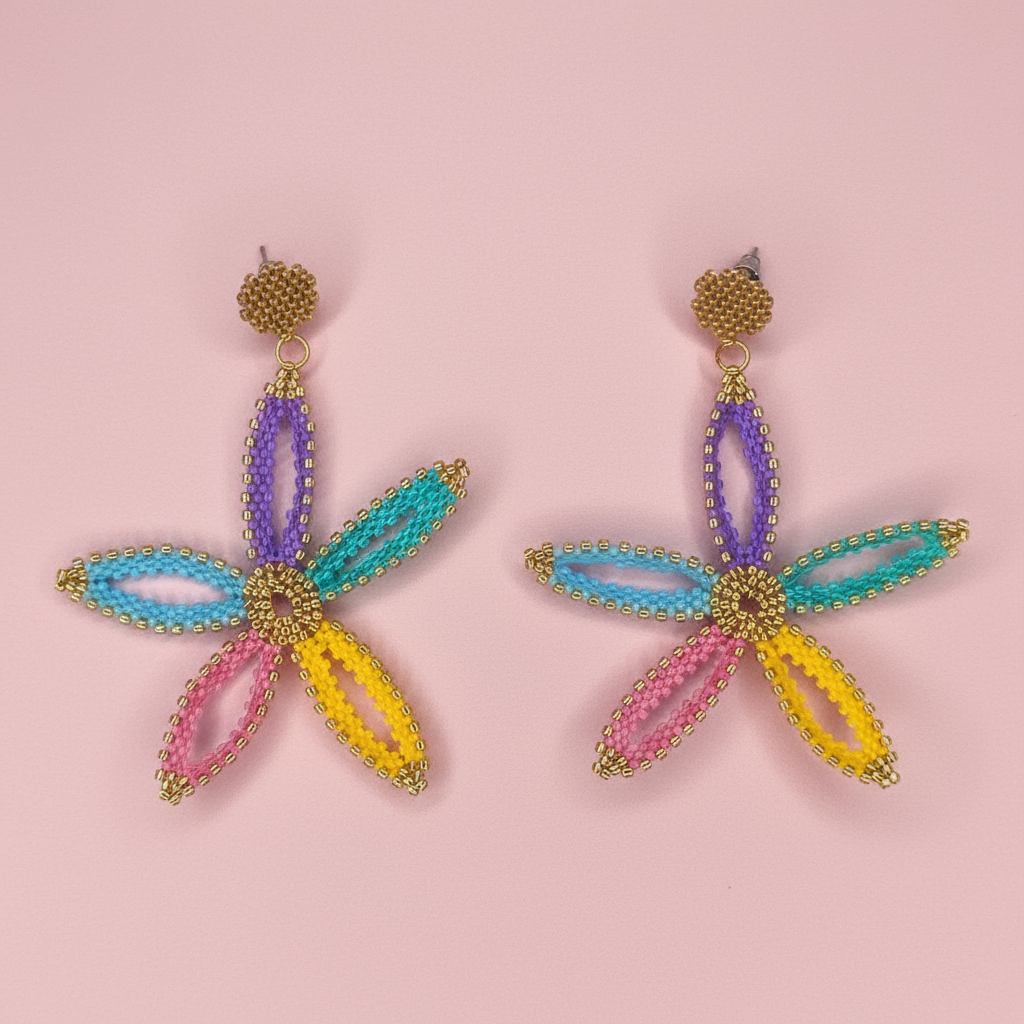 Colorful flower shaped beaded earrings on a pink background - Beadzy